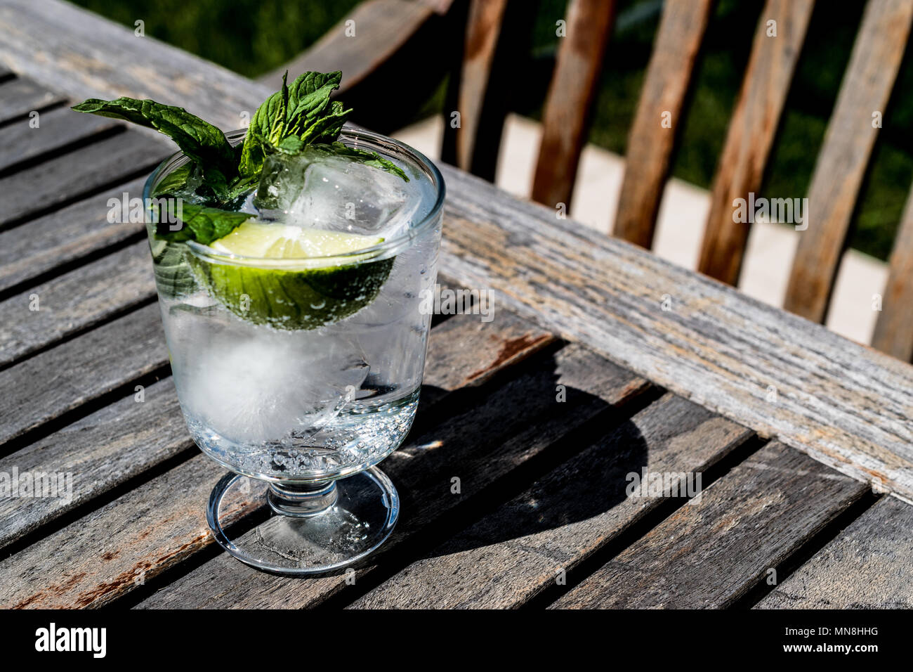 Vodka or Gin Tonic Cocktail with lime, mint leaves and ice at the