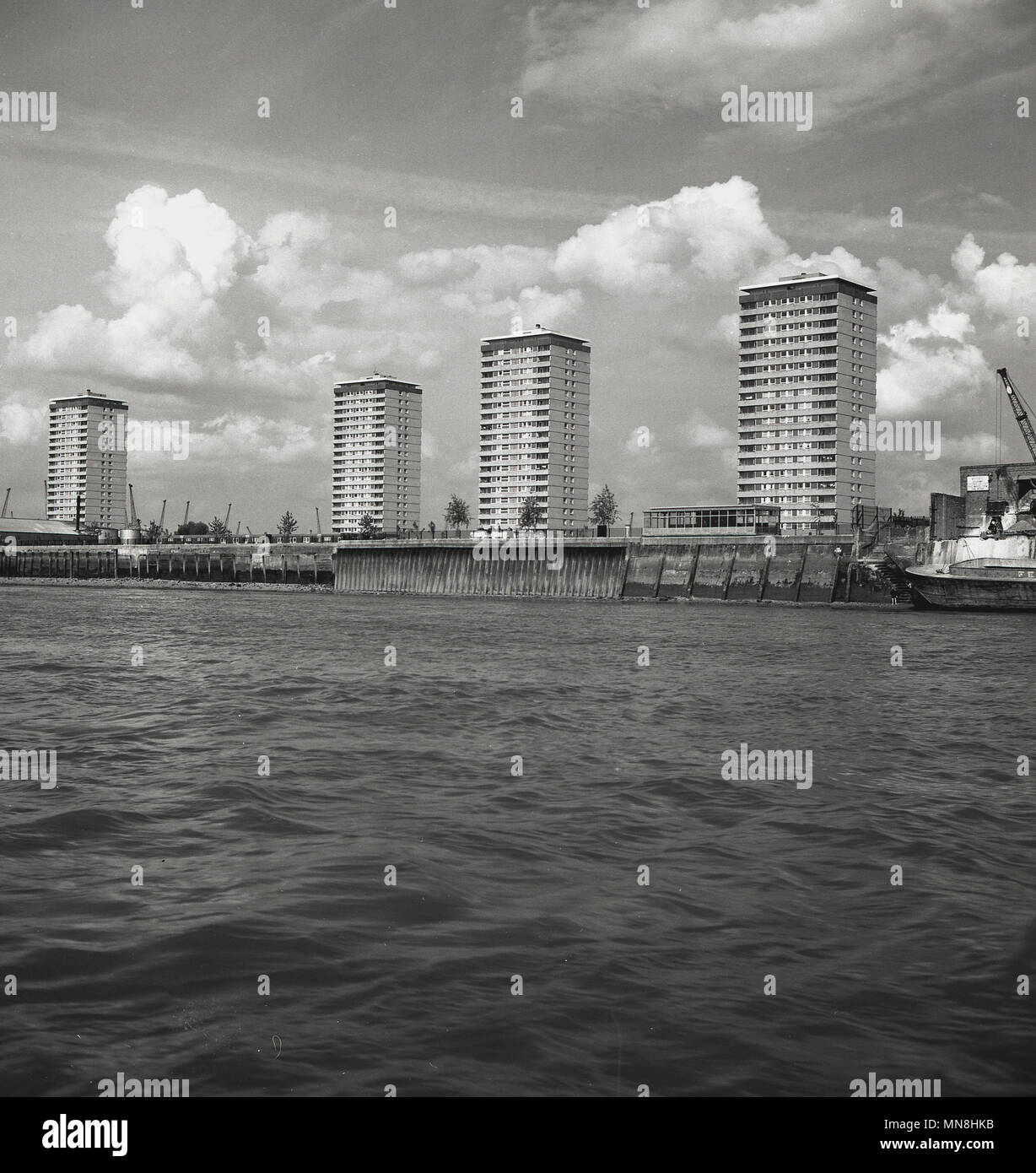 1960s, picture shows four newly built high-rise tower blocks alongside the banks of the River Thames, London, England, UK.. In this era, 'modern' concrete built residential tower blocks - known for their 'brutalist' architecture - became a common sight as local authorities believed that this was 'progress'. Whether this was true or not - and evidence proves not - one thing can be certain, they changed the skykine of the city for ever. Stock Photo