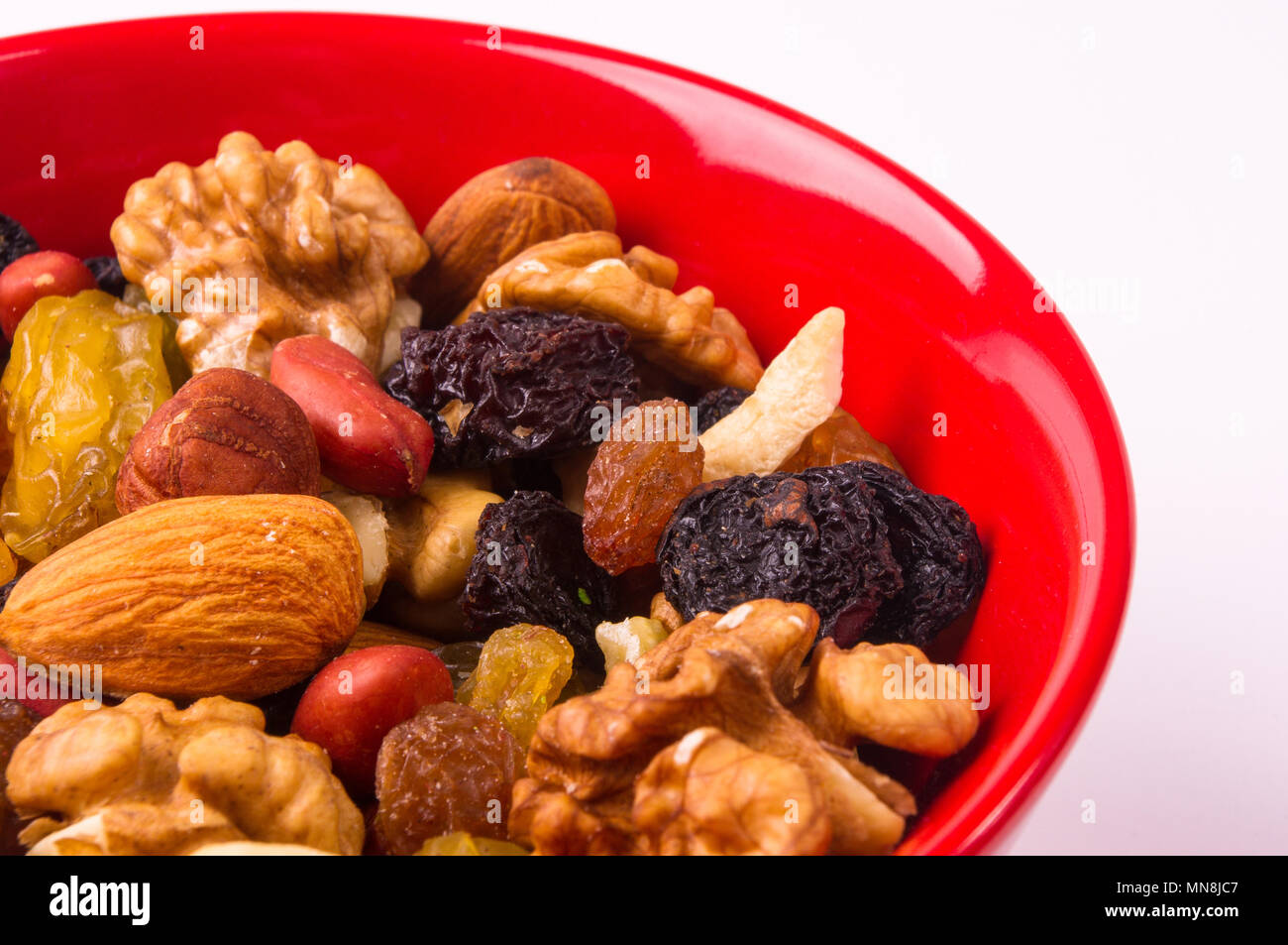 various different mixed nuts and raisins on white background Stock