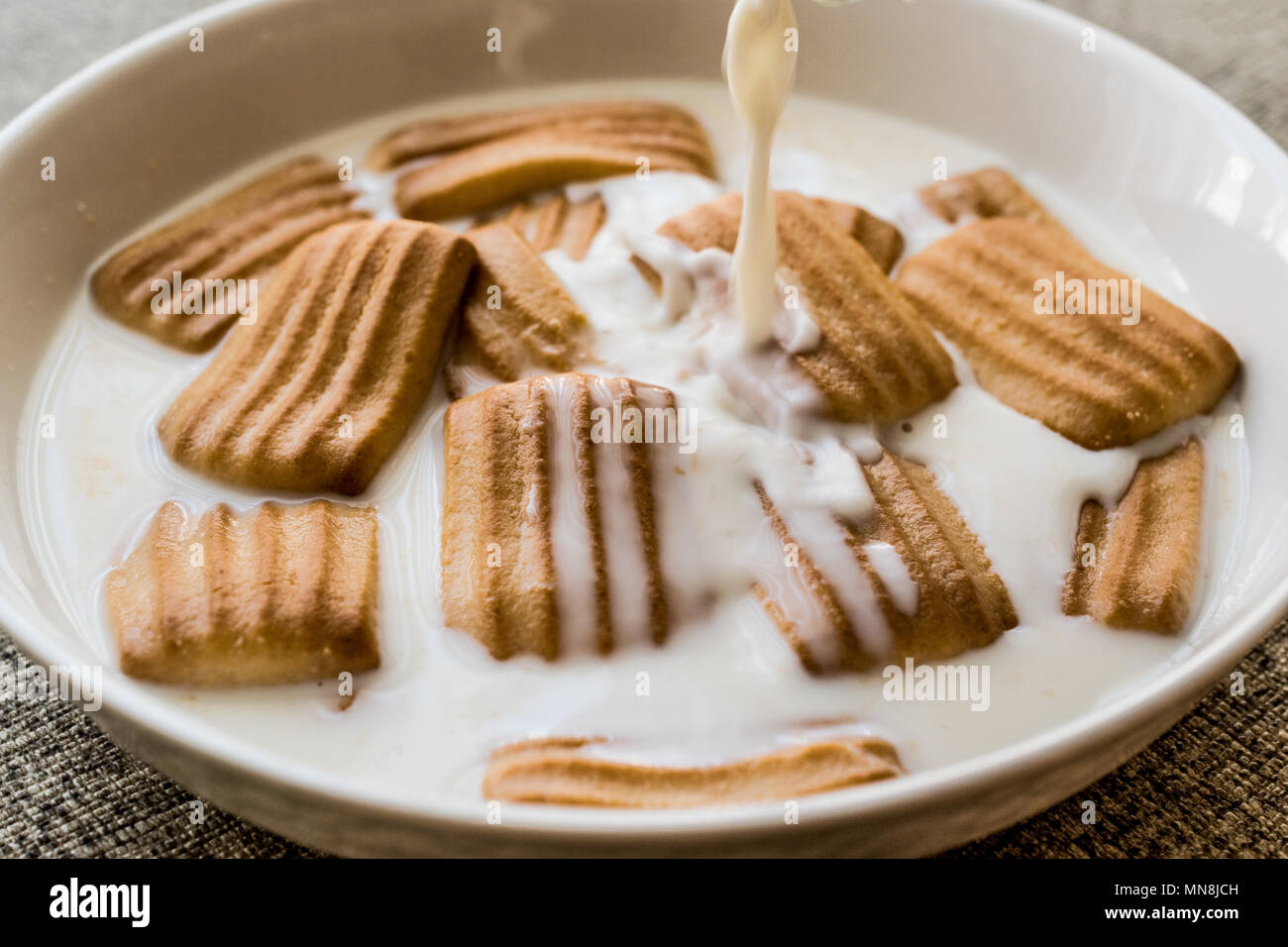 Pouring Milk To Baby Biscuit Baby Food Concept Stock Photo Alamy