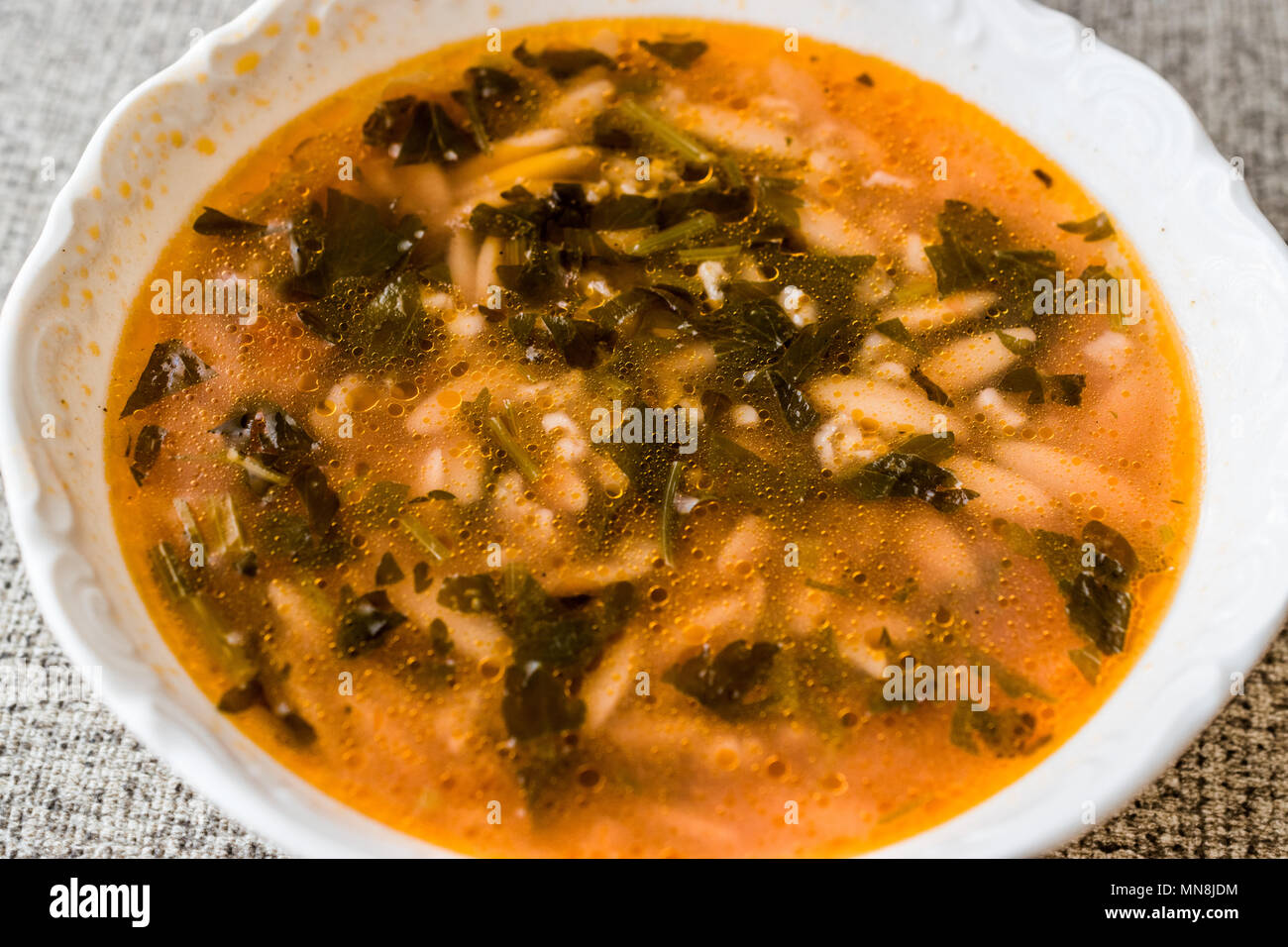 Orzo soup with barley, bulgur and parsley / arpa sehriyeli corba. Organic food concept. Stock Photo