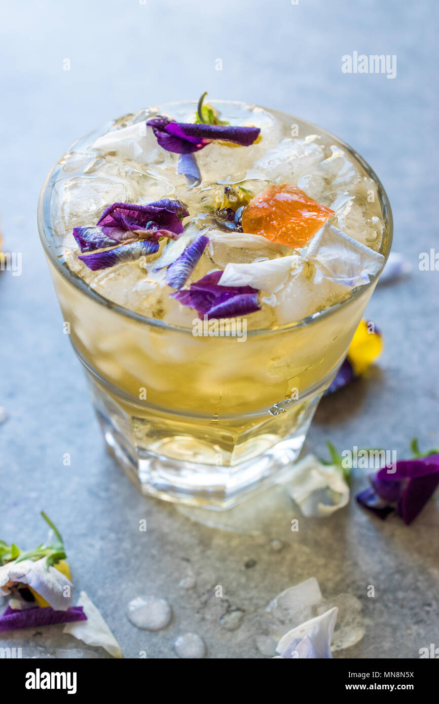 Herbal Iced Tea Cocktail With Edible Flowers And Crushed Ice - 