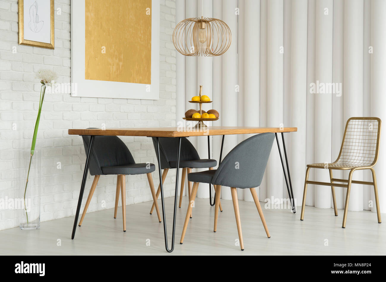 Simple Dining Room Interior With Gold Painting On White