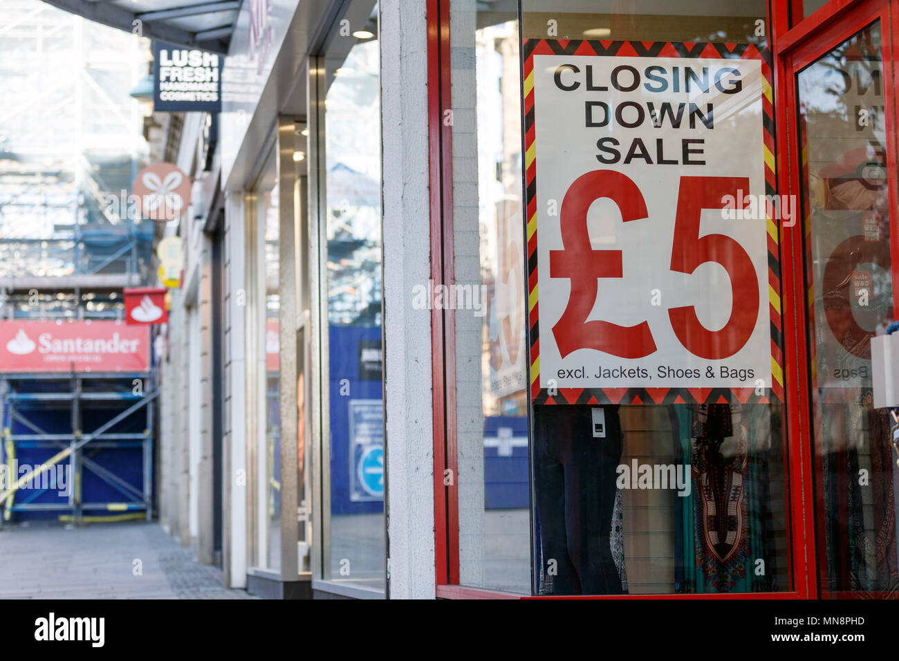 A high street shop advertising a closing down sale with all items priced at £5. Stock Photo