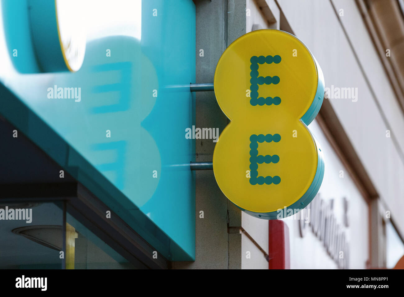 A high street branch of EE (formerly Everything Everywhere) in the United Kingdom / EE logo, EE sign, EE high street. Stock Photo