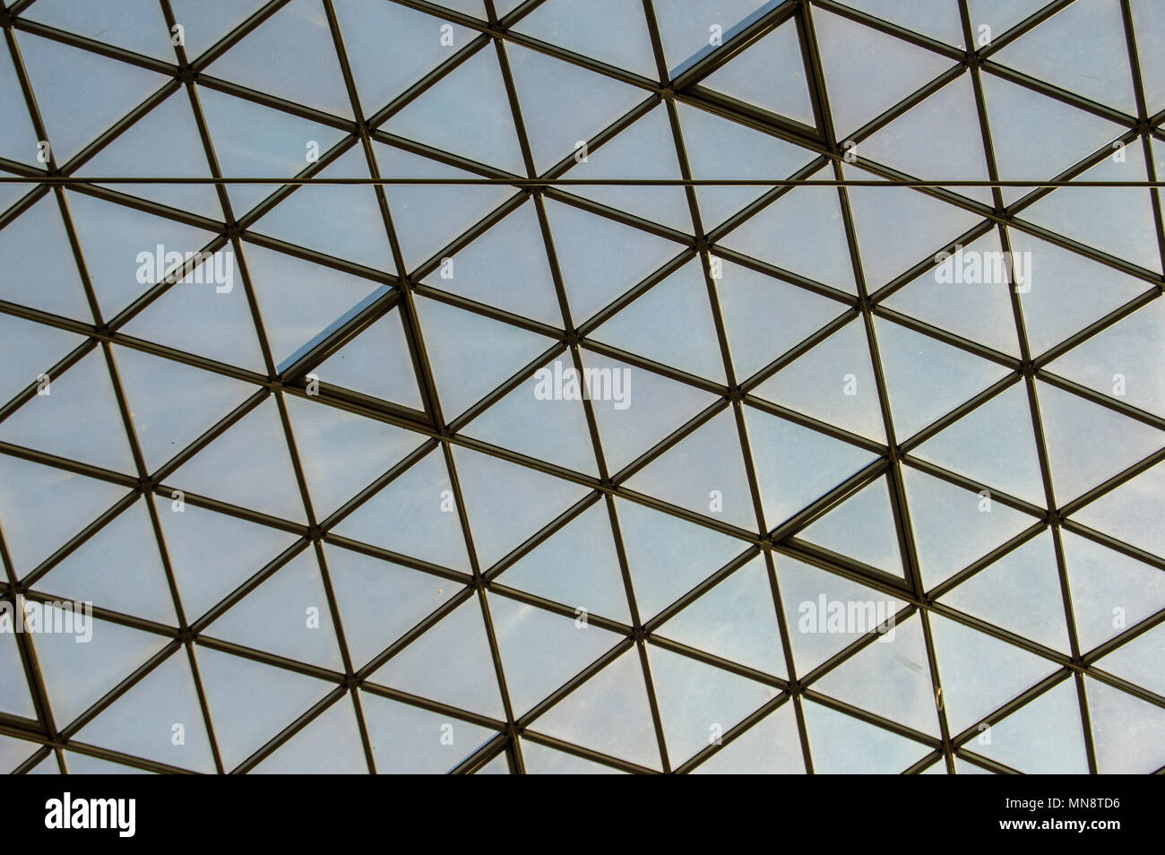 glass ceiling with metal structure in the shape of rhombs and glass of a building in Madrid. Spain Stock Photo