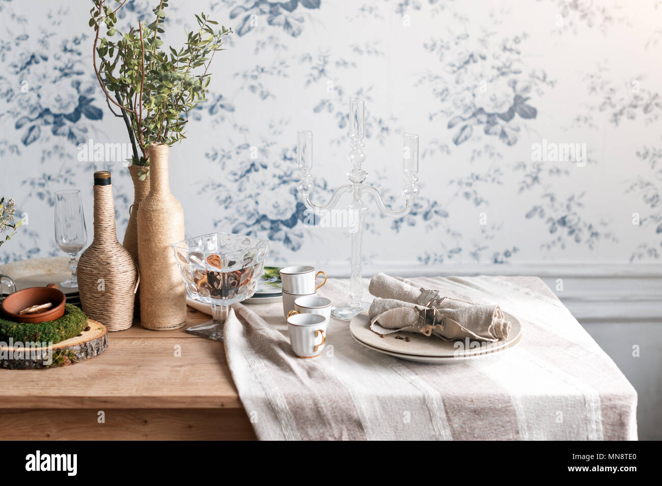 Rustic table setting. Eco friendly design Vintage interior with wood, antique cups, dishes and cutlery. Stock Photo