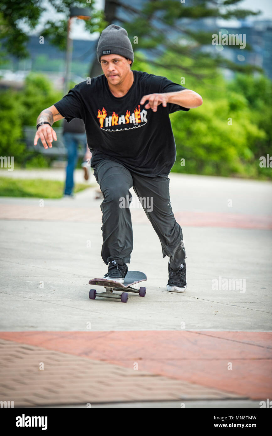 Picture of a young person pushing a skateboard in a park Stock Photo - Alamy