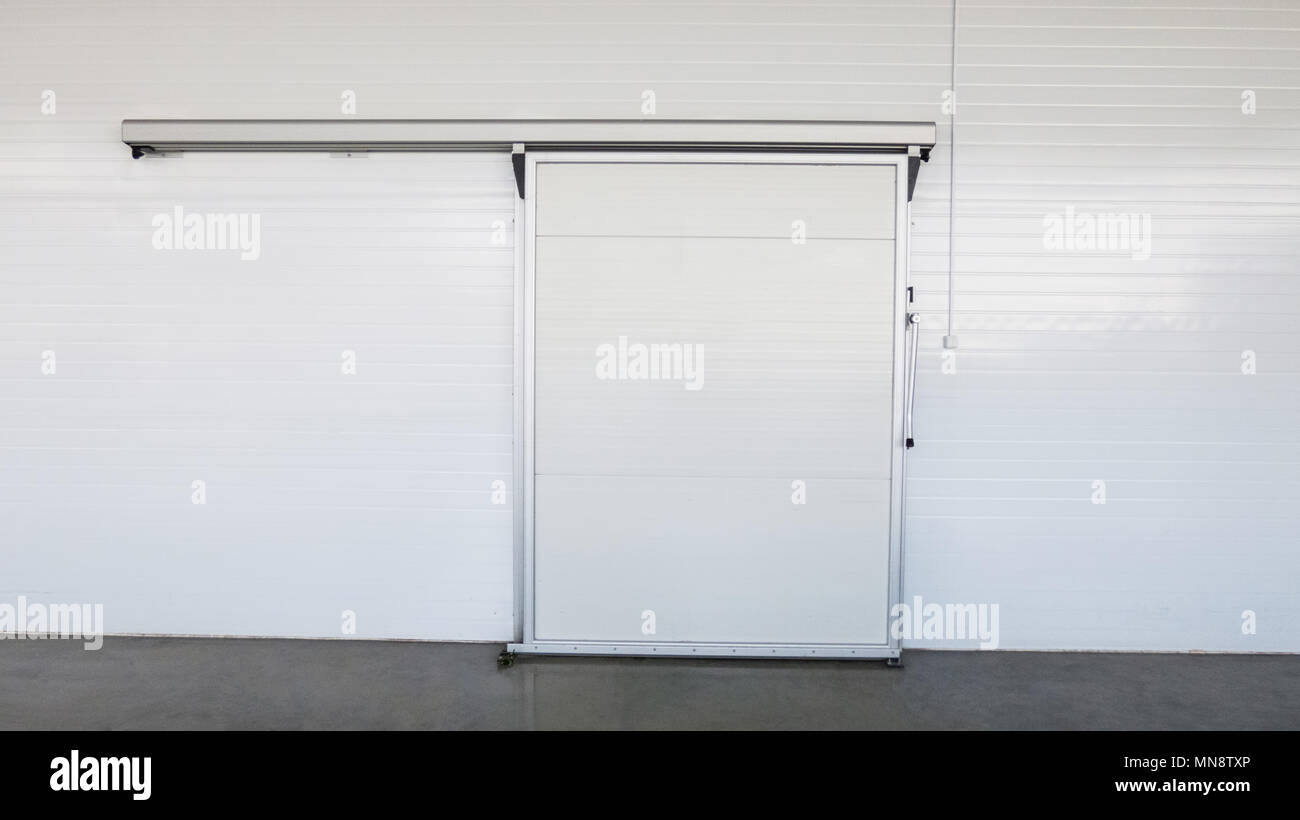 large freezer storage in the factory. closed door from warehouse Stock Photo