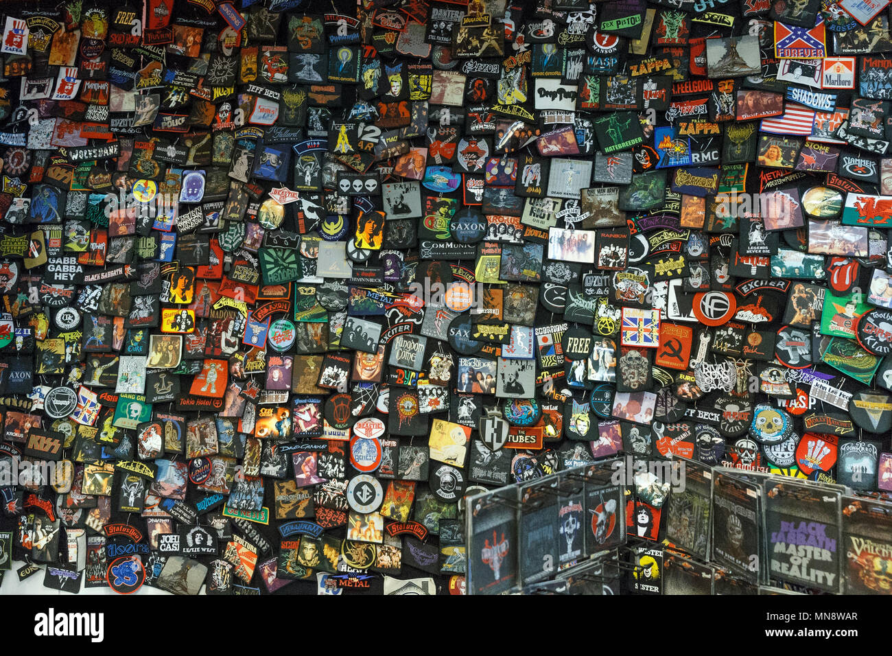 A wall of band patches and music badges on display at a rock music festival. Stock Photo