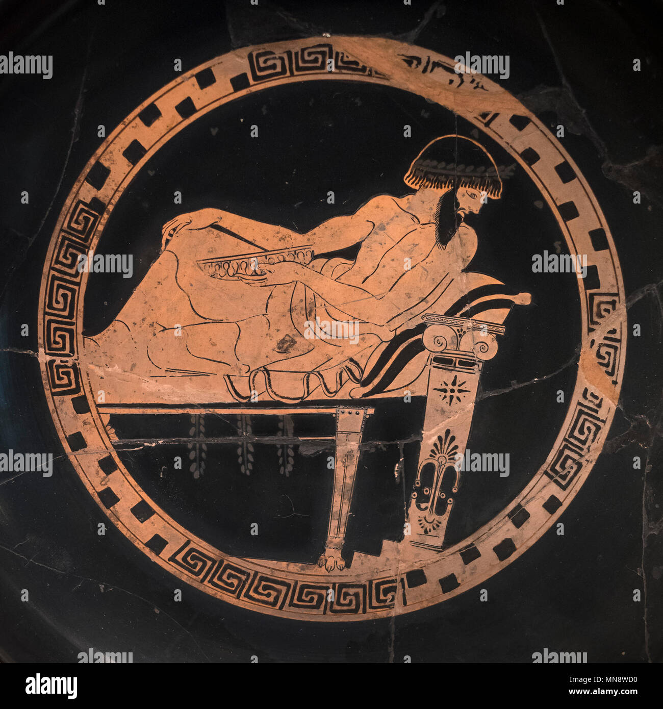 Berlin. Germany. Altes Museum. Symposiast with Cup on a Kline (Dining couch). Cup / Kylix, Attic red-figure, Antiphon Painter. From Vulci, Italy. Clay Stock Photo
