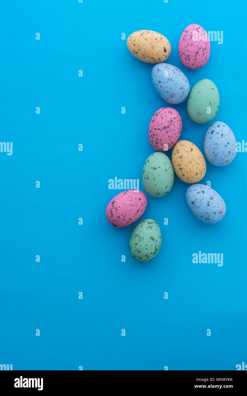 Mini speckled easter eggs from above on colourful backgrounds, with copyspace. Stock Photo