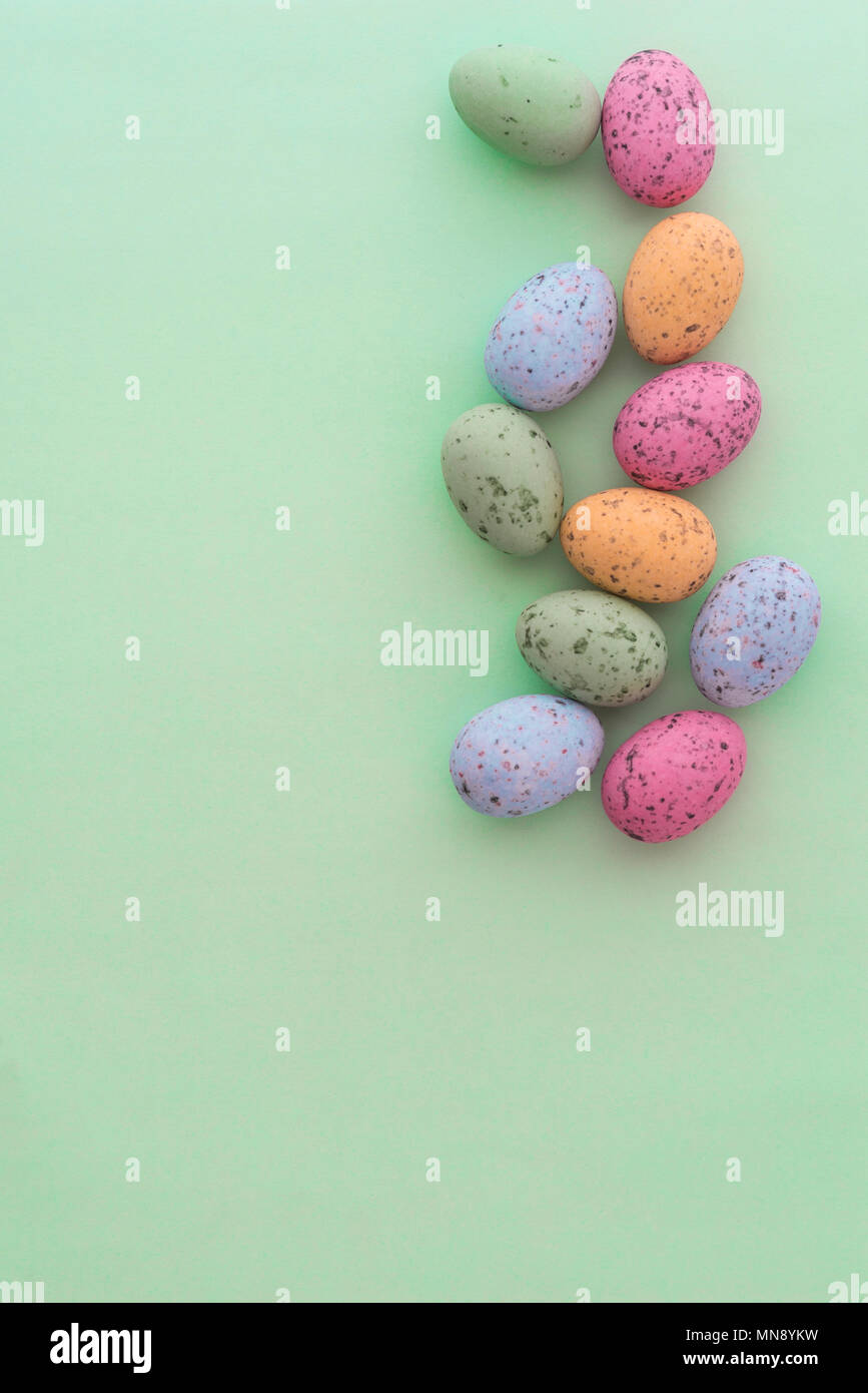 Mini speckled easter eggs from above on colourful backgrounds, with copyspace. Stock Photo