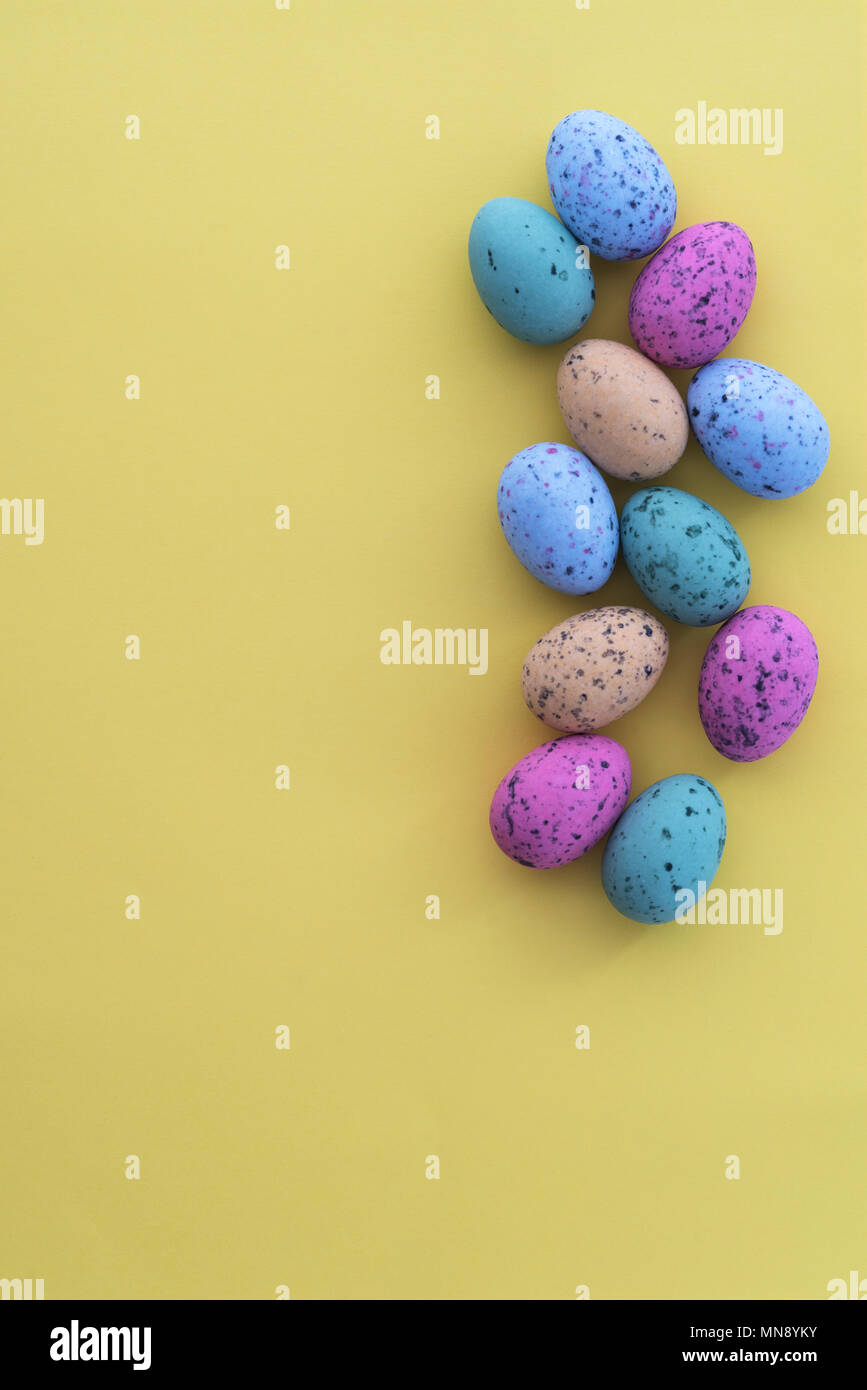 Mini speckled easter eggs from above on colourful backgrounds, with copyspace. Stock Photo
