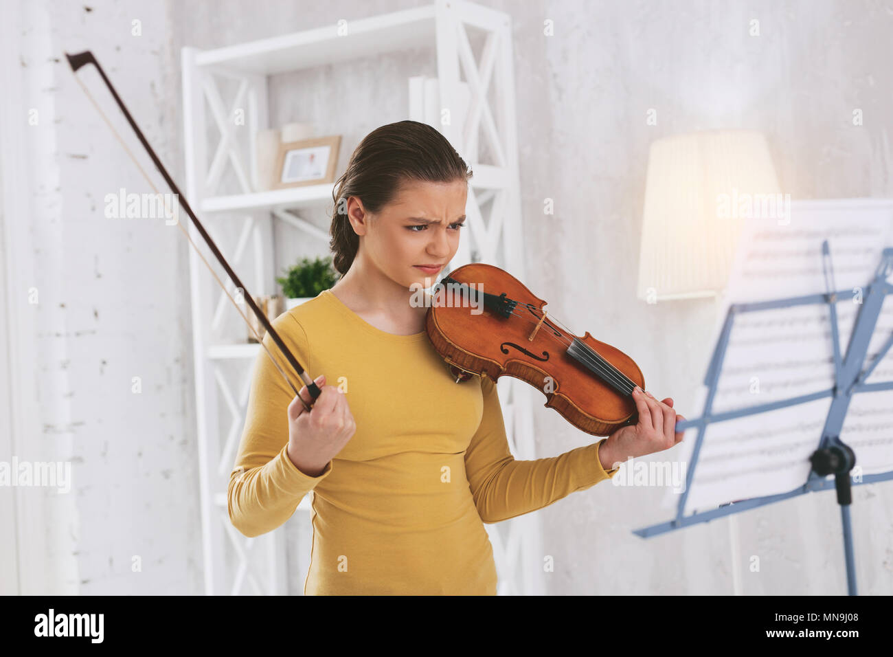 Angry girl looking at notes Stock Photo - Alamy
