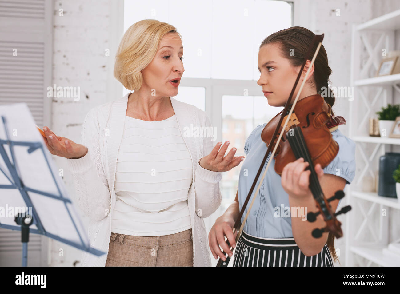 Angry girl looking at her tutor Stock Photo