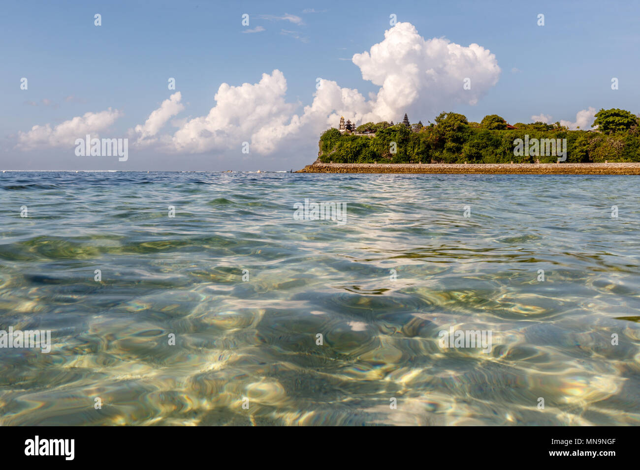 Geger beach and Pura Geger, clouds and ocean water. Nusa Dua, Bali, Indonesia. Stock Photo