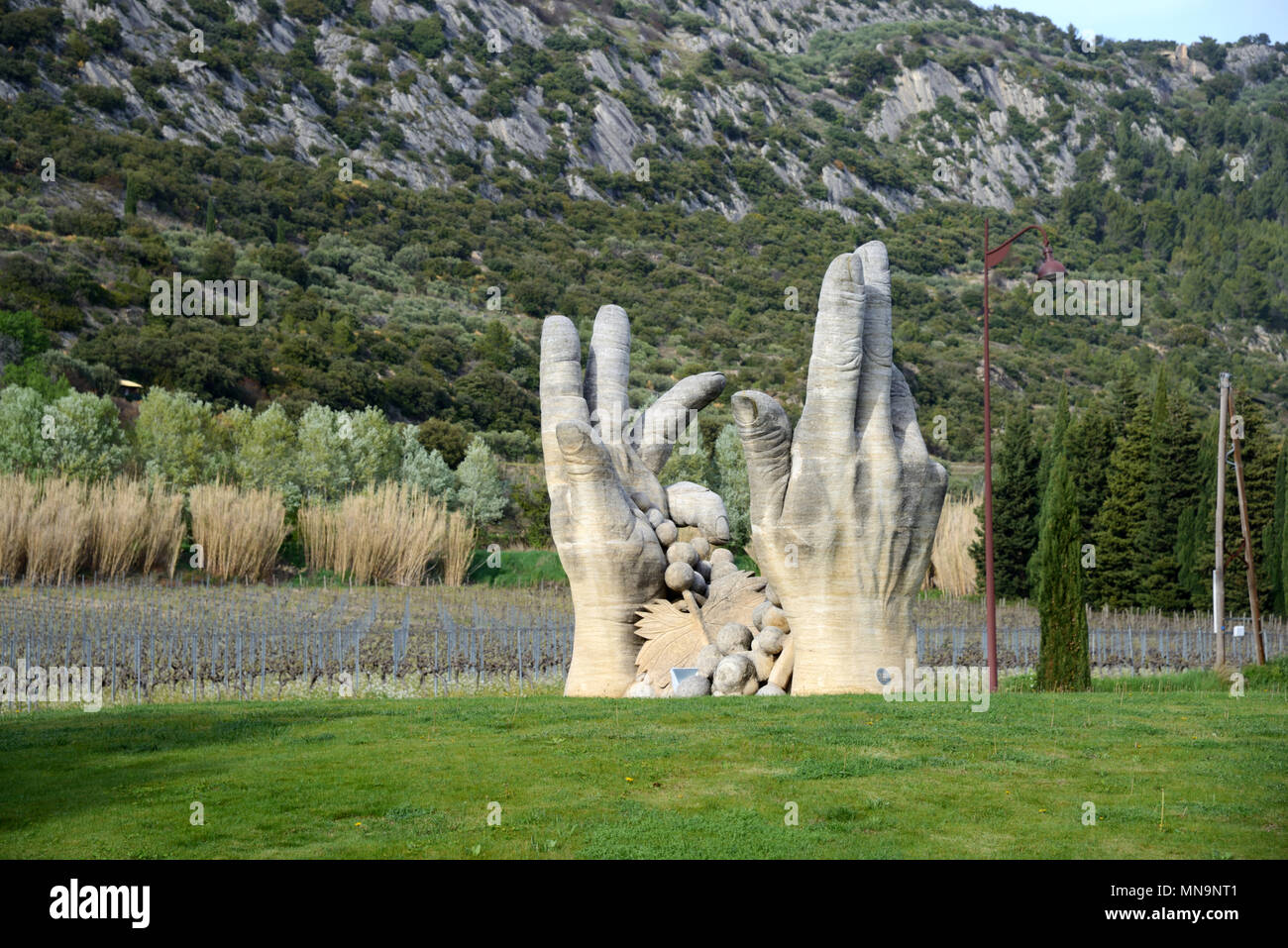 Hand Sculpture of Grape Pickers on Roundabout Outside Winery of Beaumes de Venise Vaucluse Provence France Stock Photo