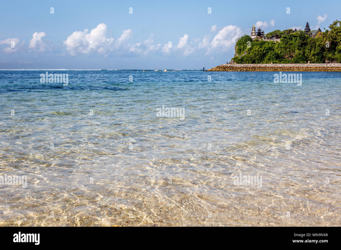 Geger beach and Pura Geger, clouds and ocean water. Nusa Dua, Bali, Indonesia. Stock Photo