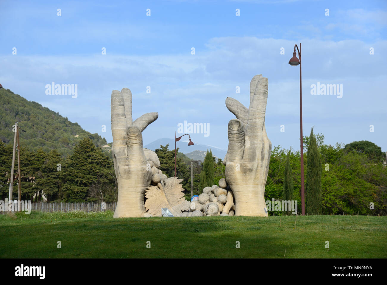 Hand Sculpture of Grape Pickers on Roundabout Outside Winery of Beaumes de Venise Vaucluse Provence France Stock Photo