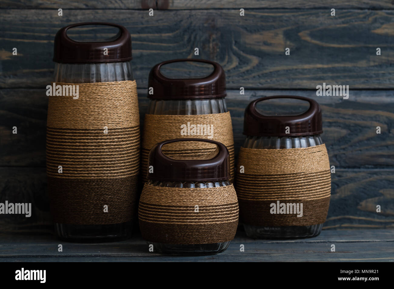 Rope Wrapped Decorative Glass Jars On Blue Wooden Background Stock