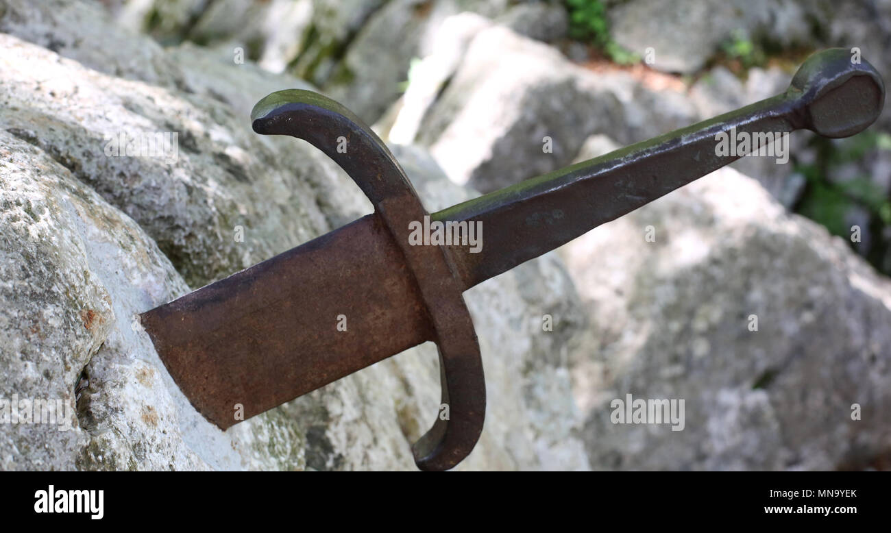 Excalibur symbol of success is a legendary sword in the stone of King Arthur Stock Photo Alamy