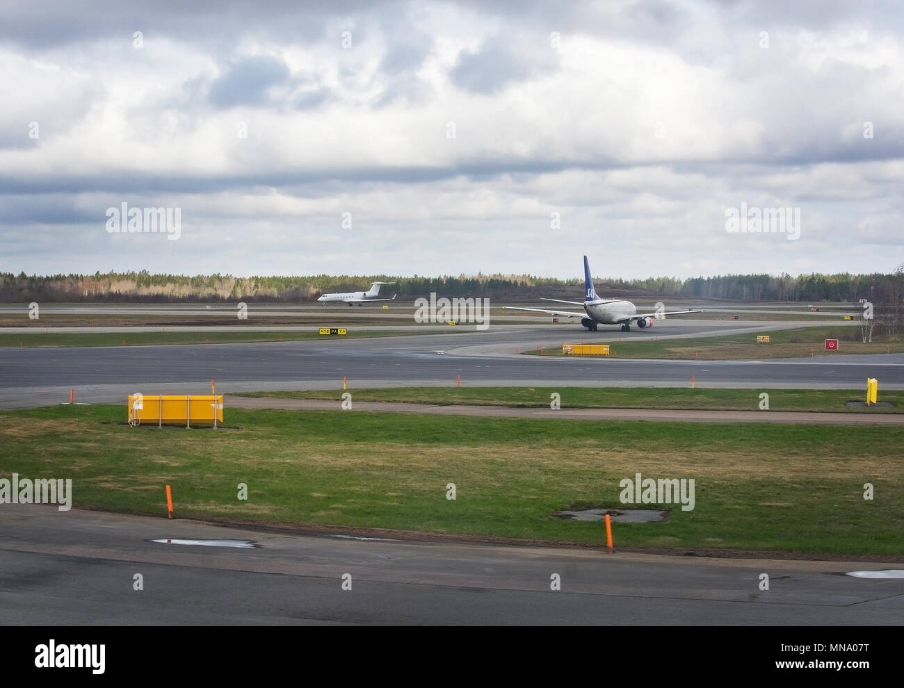 STOCKHOLM, SWEDEN - APRIL 27, 2018: Arlanda airport tarmac and small white government aircraft with three crowns symbol leaves Stock Photo