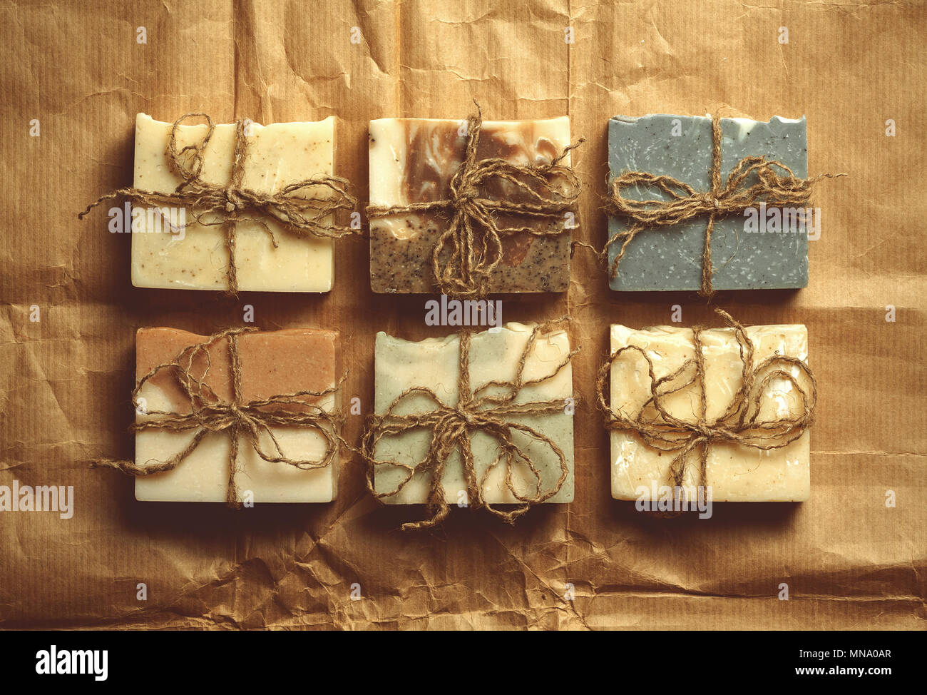 Organic handmade soap on crumpled packing paper. Stock Photo