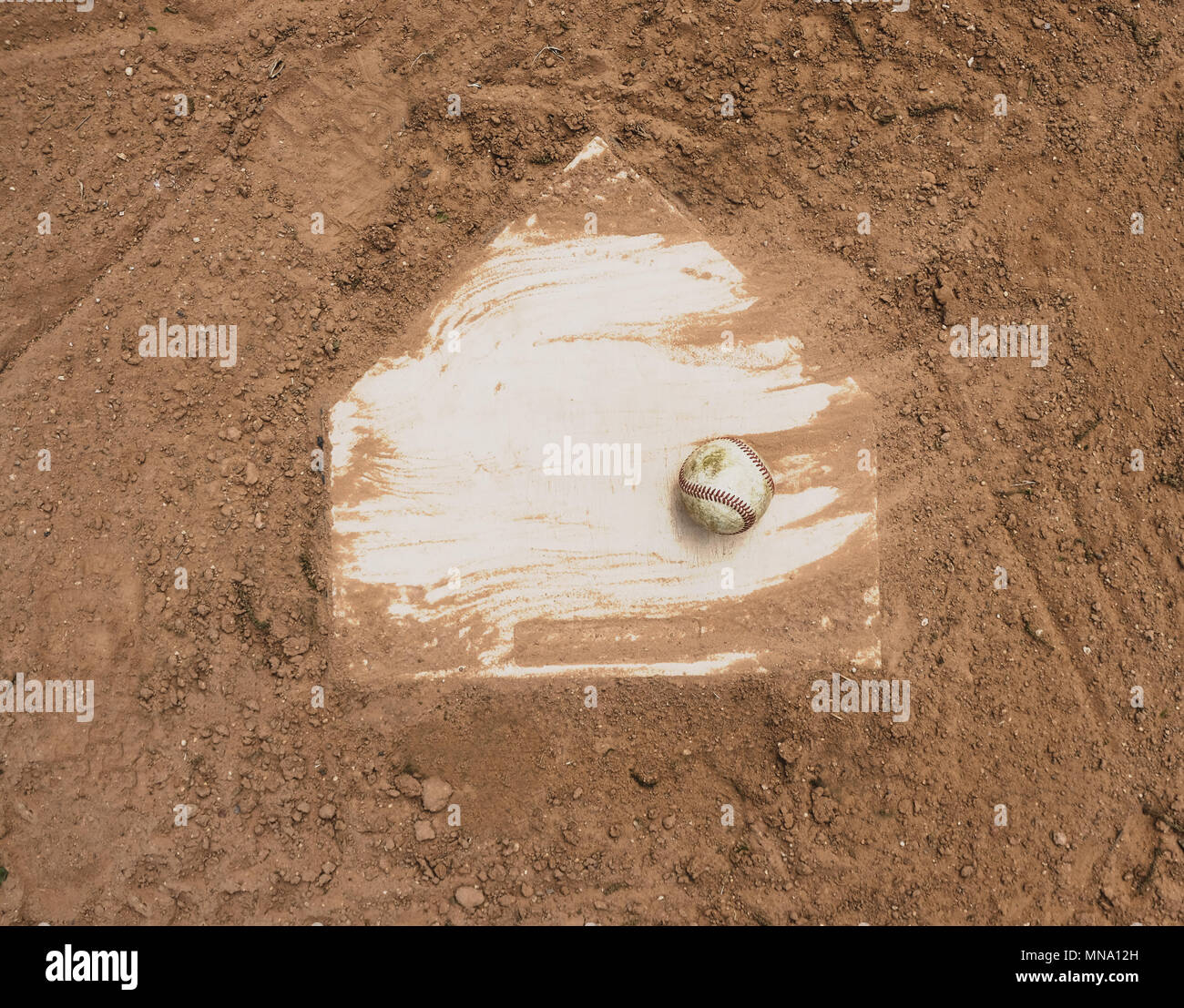 Baseball laying with homeplate on dirt field for game Stock Photo Alamy