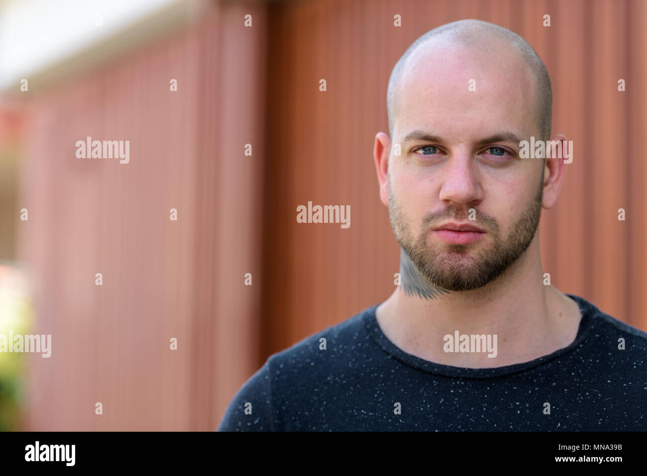 Portrait of young bald muscular man outdoors Stock Photo