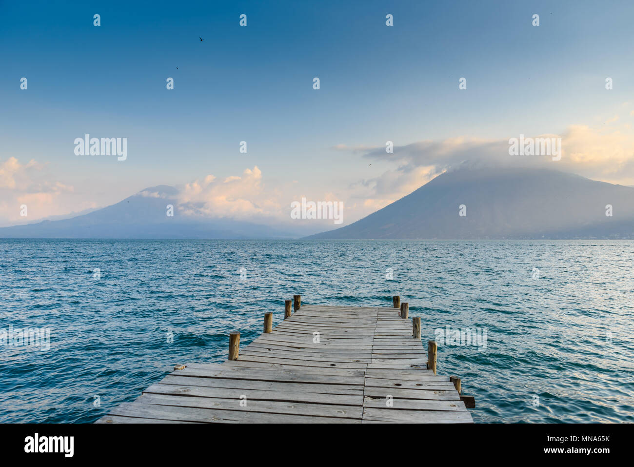 Pier at San Marcos La Laguna with beaufiful scenery of Lake Atitlan and volcanos - Guatemala Stock Photo