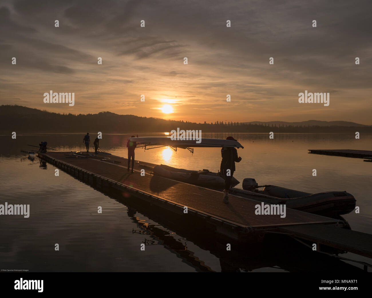 Varese. Lombardy. Province of Varese. ITALY.    General View. Varese Rowing Club. [Canottieri Varese] Province of Varese.  Carrying Boat, double scull, boating-pontoon, reflection,  low sun, setting, atmospheric, Lake Varese, Sunset   Monday  02/01/2017  © Peter SPURRIER. Stock Photo