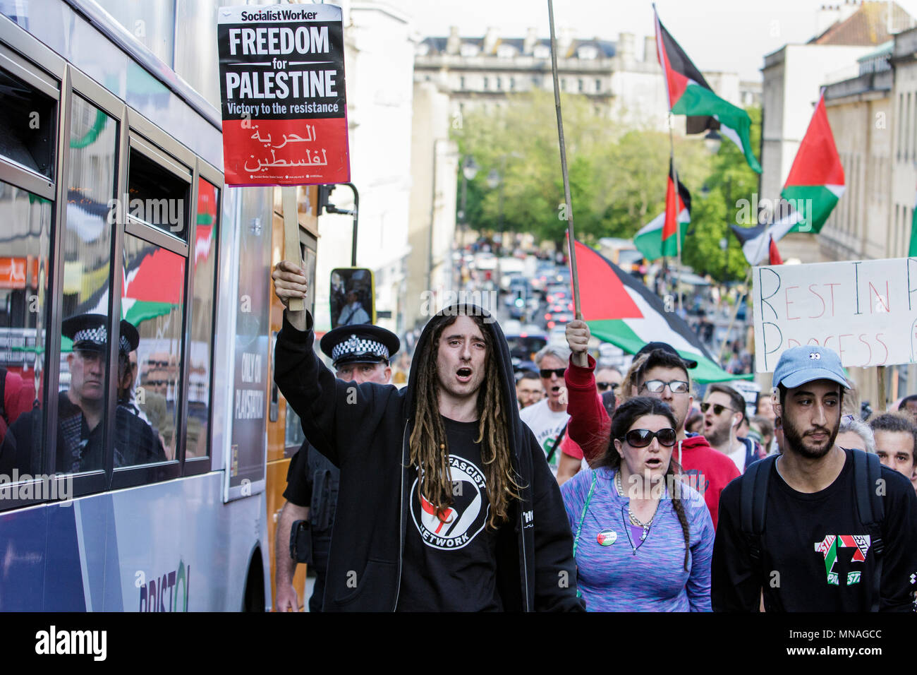 Bristol, UK. 15th May, 2018. Pro-Palestinian demonstrators holding placards and waving Palestinian flags are pictured as they march through Bristol in a protest march to show their solidarity with the Palestinian people. The protest march and rally was held to allow people to show their support and solidarity with the Palestinian people after 70 Years of Nakba and to protest about Israel's recent actions in Gaza Stock Photo