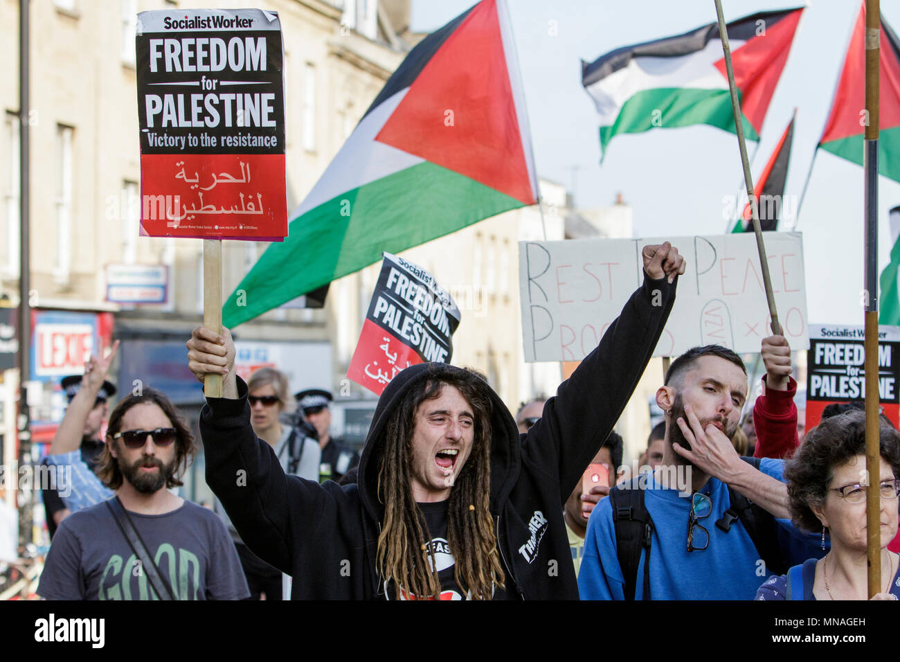 Bristol, UK. 15th May, 2018. Pro-Palestinian demonstrators holding placards and waving Palestinian flags are pictured as they march through Bristol in a protest march to show their solidarity with the Palestinian people. The protest march and rally was held to allow people to show their support and solidarity with the Palestinian people after 70 Years of Nakba and to protest about Israel's recent actions in Gaza Stock Photo