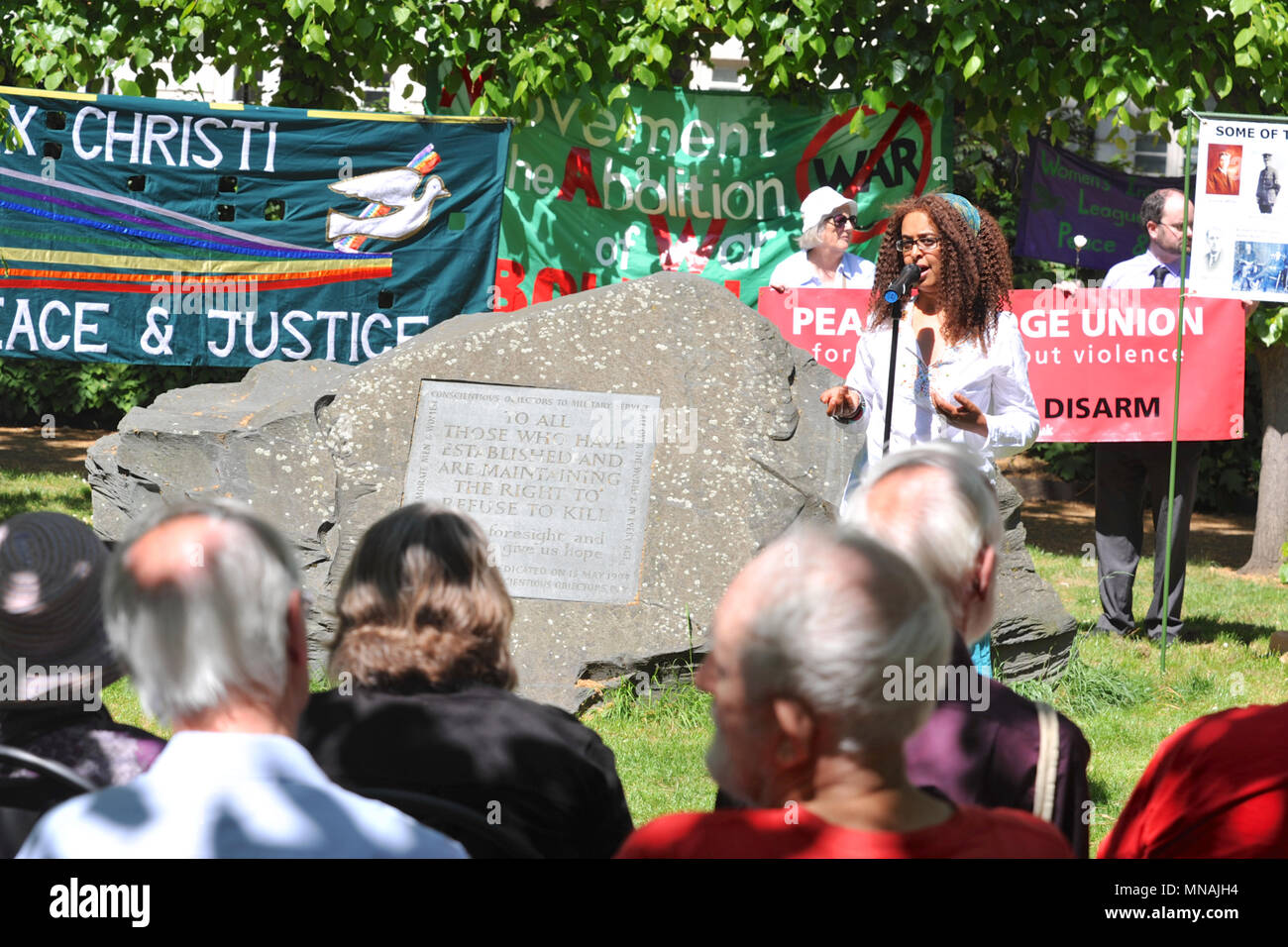 London, UK. 15th May 2018. Selam Kidane (Eritrean human rights activist) speaking at the Conscientious Objectors Commemorative Stone, during a ceremony of remembrance held in Tavistock Square, London, UK to mark Conscientious Objectors Day.  79 white carnations were laid at the stone to commemorate various people who have historically refused to kill. Credit: Michael Preston/Alamy Live News Stock Photo