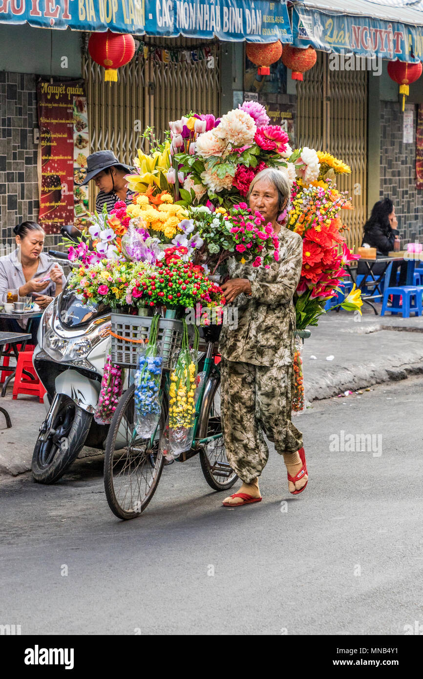 Mobile vendor selling flowers on streets of Saigon Vietnam Stock Photo Alamy