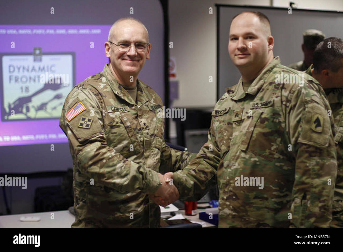 Brig. Gen. Scott Campbell presents Sgt. William Wickstrom with a coin ...