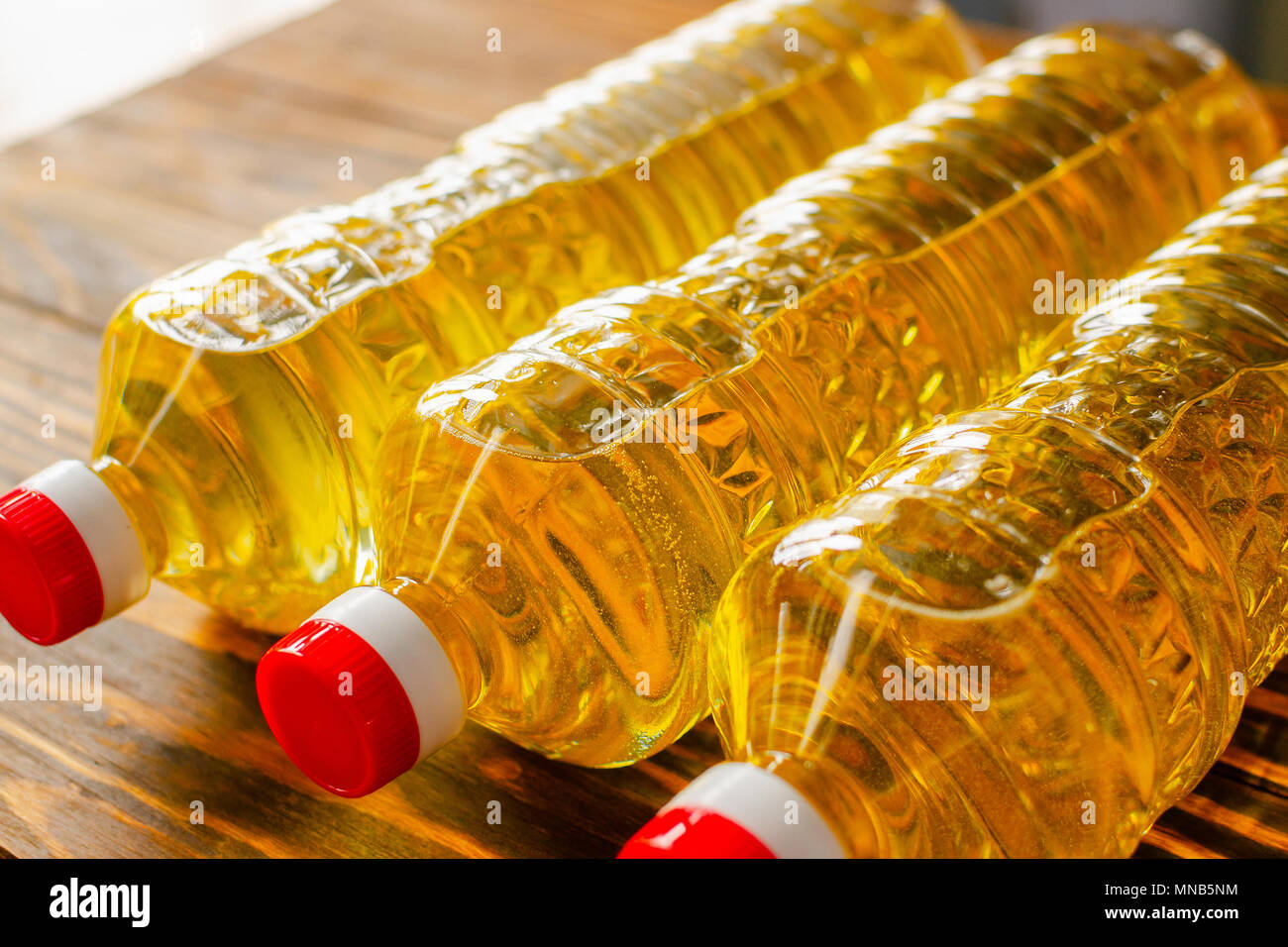 Sunflower oil. Olive oil. Bottles with butter on a wooden table. Stock Photo