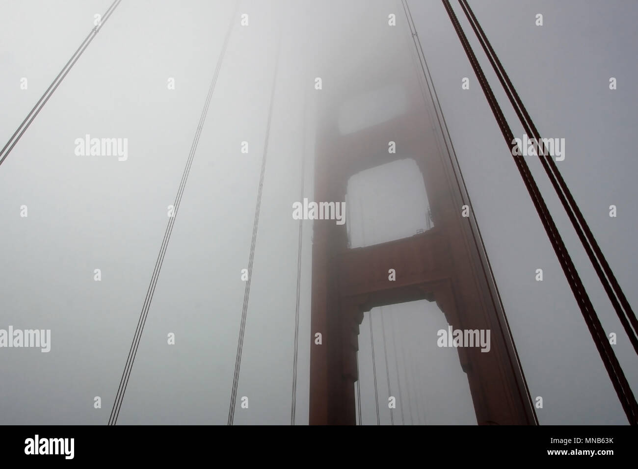 Golden Gate Bridge tower with fog rolling, San Francisco Stock Photo