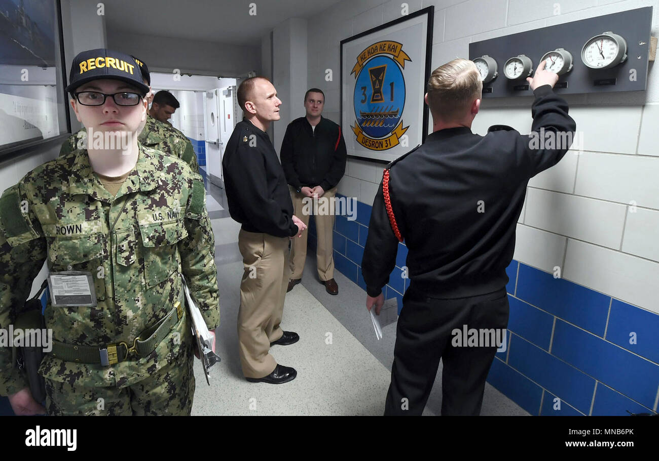LAKES, Ill. (March 15, 2018) Gas Turbine Systems Technician (Mechanical) 1st Class Benjamin McCarty, a recruit division commander, explains new watch standing training, like reading gauges, to Master Chief Petty Officer of the Navy (MCPON) Steven Giordano in a recruit barracks at Recruit Training Command (RTC).  MCPON was at the RTC to see changes in the curriculum to more intensive hands-on training. Training includes physical fitness, seamanship, firearms, firefighting and shipboard damage control along with lessons in Navy heritage and core values, teamwork and discipline. (U.S. Navy Stock Photo