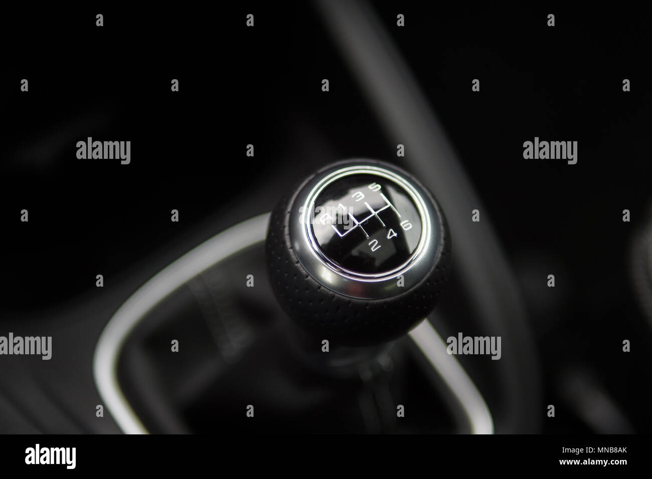 Manual transmission gear stick. The shifter is black, silver, and sleek