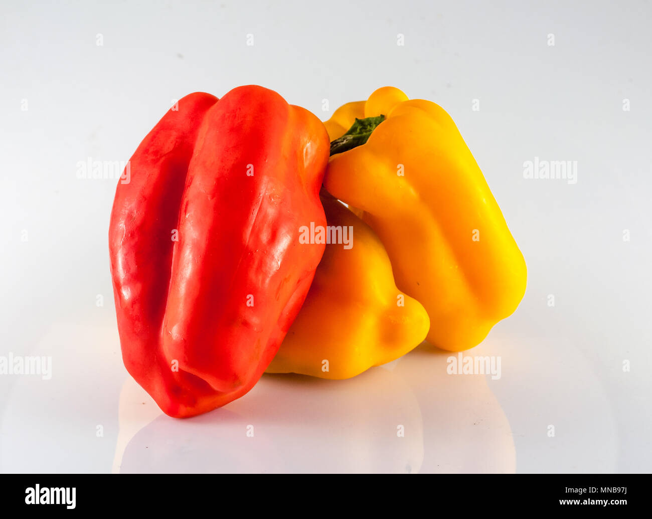 isolated red and yellow peppers on white background Stock Photo - Alamy