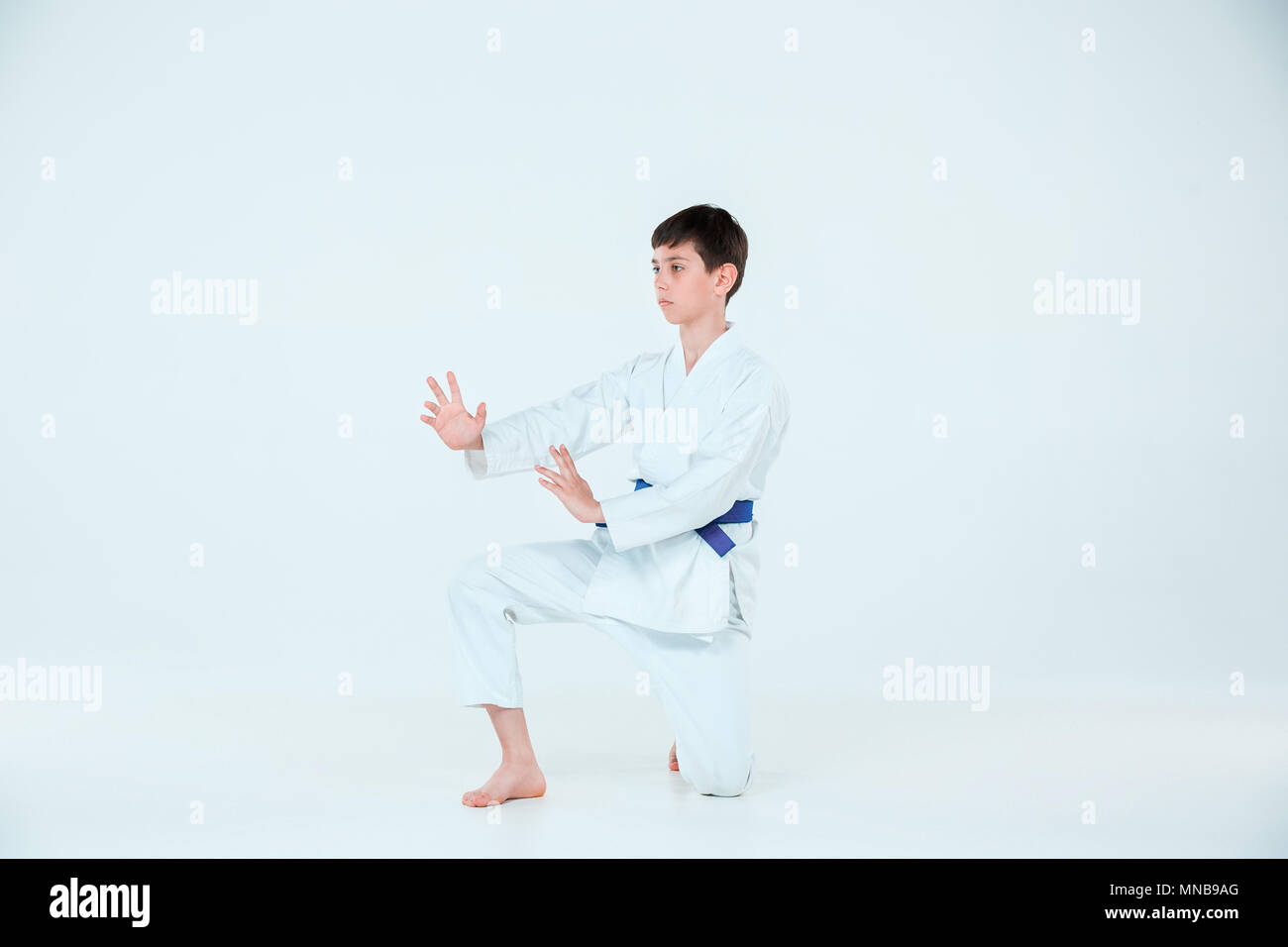 The boy posing at Aikido training in martial arts school. Healthy lifestyle and sports concept Stock Photo