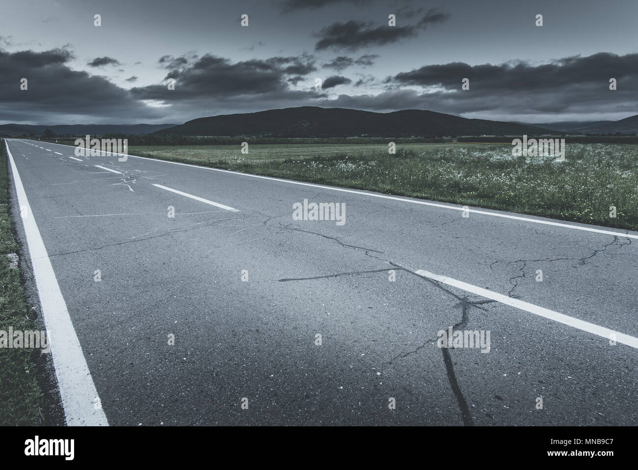 cloudy sky over country road Stock Photo - Alamy