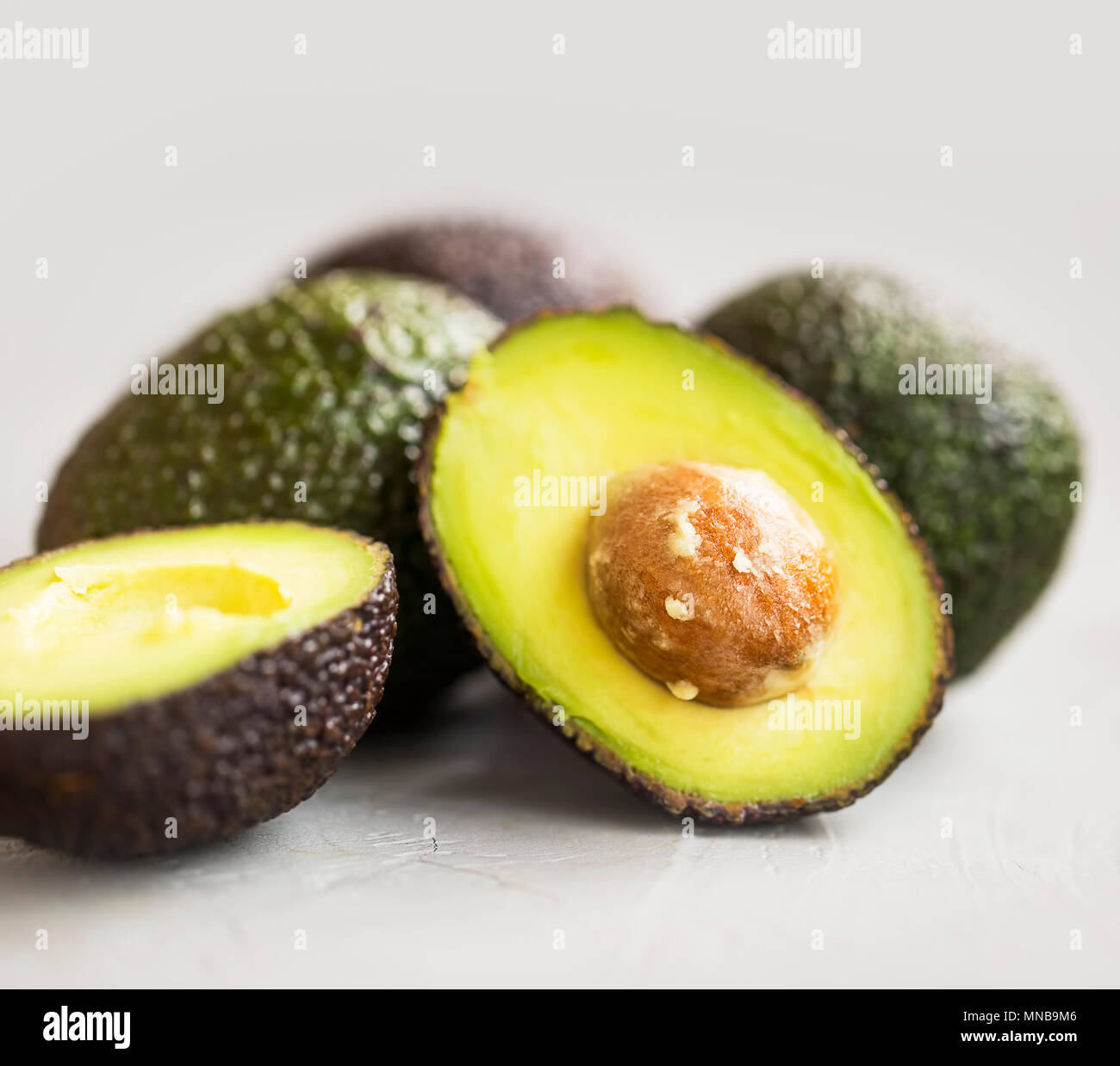 Healthy avocado fruits, half and wholes of avocado Stock Photo