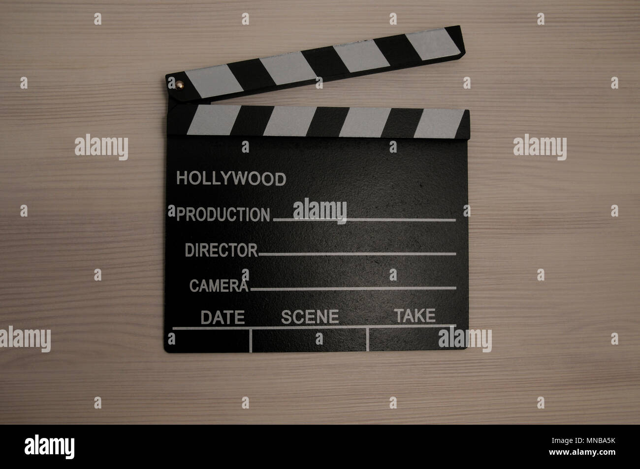 Clapboard on white wooden background Stock Photo