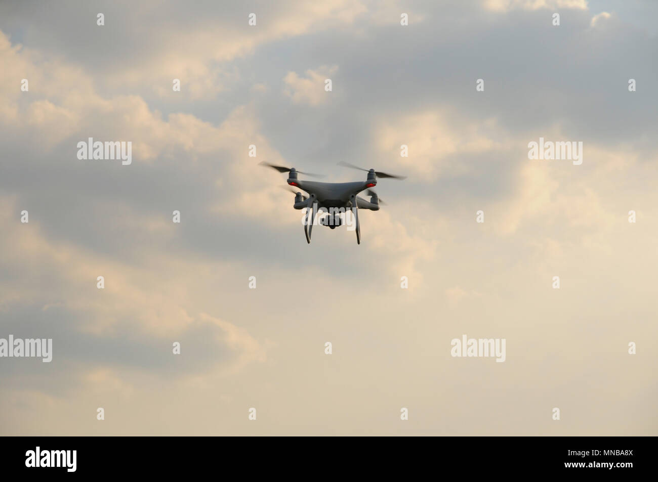 Drone quadrocopter in the sky watching Stock Photo