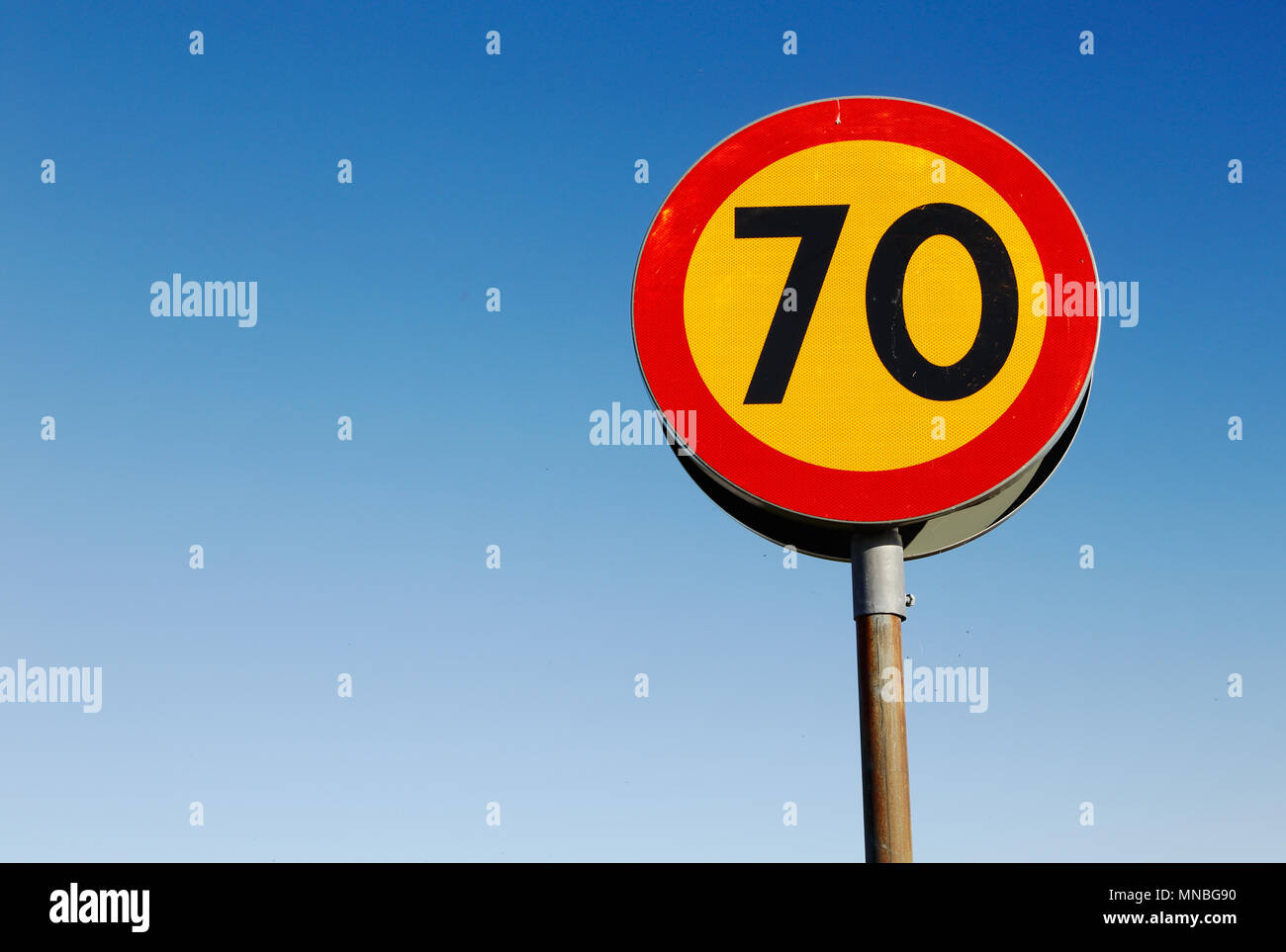 One speed linit sign 70 kmh against a blue sky. Stock Photo