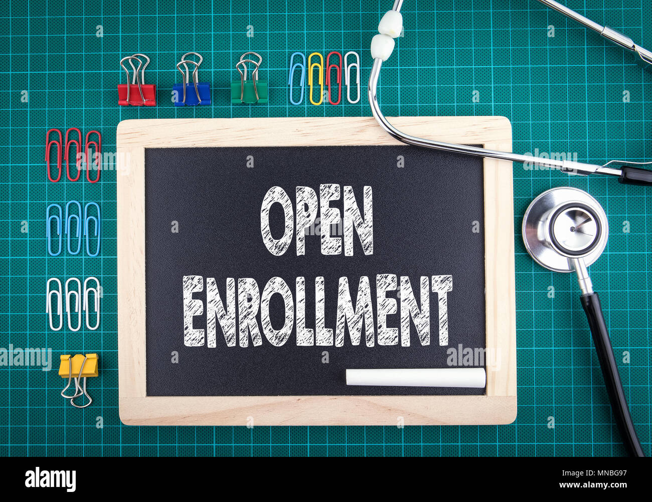 Open Enrollment concept. Medical and health background. Work desk with stationery and stethoscope Stock Photo