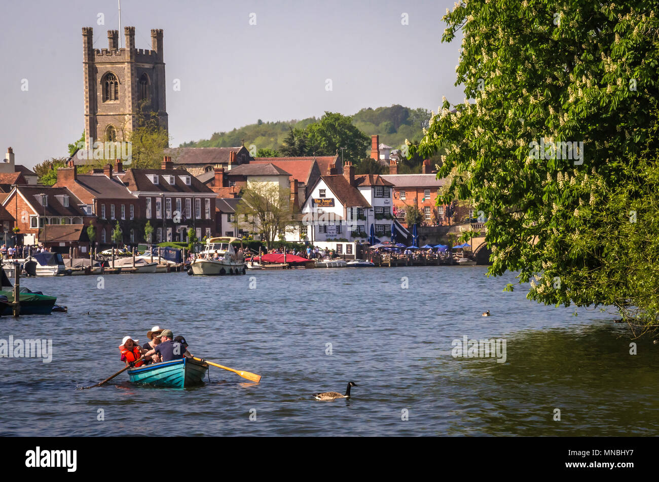 OXFORDSHIRE, UK - MAY 06, 2018: Family enjoying sunny day in boat at Henley on Thames. Henley is overlooked by a beautiful landscape of wooden hills. Stock Photo